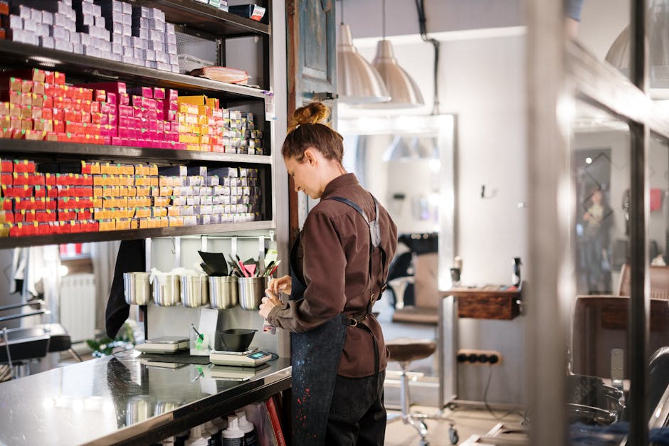 Hairdresser organizing hair color products in a modern salon